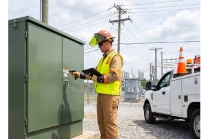 Field technician using a Fusion5 rugged Windows tablet to inspect electrical utility equipment and manage field service work orders