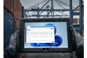 Rugged Windows tablet displaying cargo tracking software in a busy shipping port, highlighting a durable, dock-ready design for logistics and port operations.