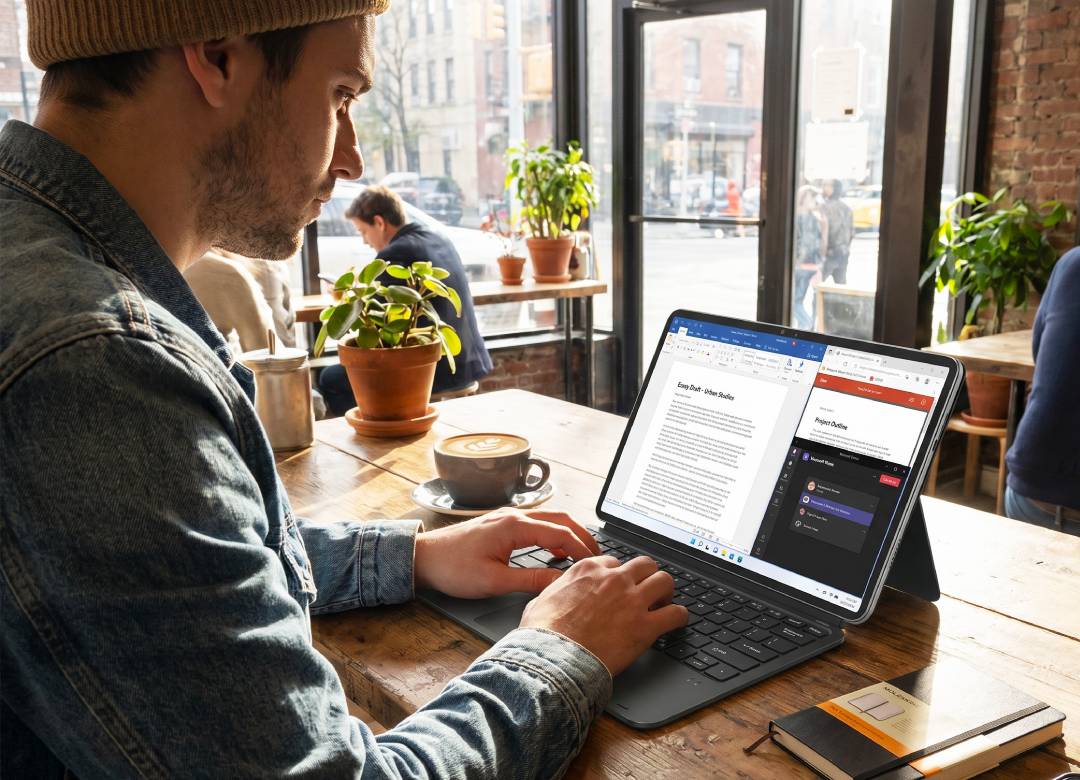 Fusion5 Helios12 Windows tablet with compatible docking keyboard used for typing, documents, web research, and productivity in a Brooklyn coffee shop